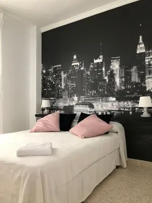 a bedroom with a bed with a view of a city at VILLA SALMONETE in Sanlúcar de Barrameda