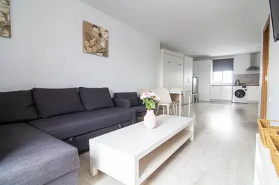a living room with a couch and a table at Apartamento Herrería centro in El Puerto de Santa María