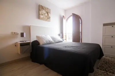 a bedroom with a bed and a window at Apartamento Herrería centro in El Puerto de Santa María