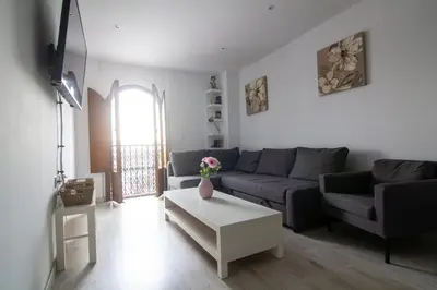 a living room with a couch and a table at Apartamento Herrería centro in El Puerto de Santa María