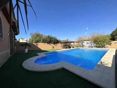 a swimming pool in the middle of a yard at Chalet Aguacate in Chiclana de la Frontera