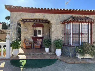 a home with a patio with potted plants on it at Chalet Aguacate in Chiclana de la Frontera