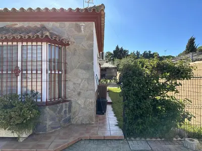 an entrance to a house with a stone wall at Chalet Aguacate in Chiclana de la Frontera