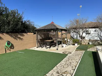 a backyard with a gazebo and artificial grass at Chalet Aguacate in Chiclana de la Frontera