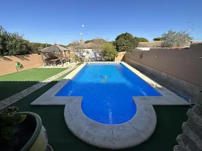 a swimming pool in a yard with aestone sidx sidx sidx at Chalet Aguacate in Chiclana de la Frontera