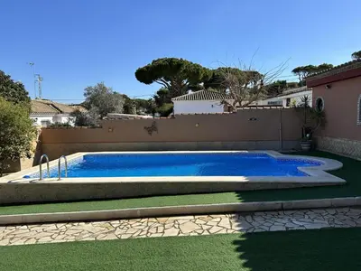 a swimming pool in a yard next to a fence at Chalet Aguacate in Chiclana de la Frontera