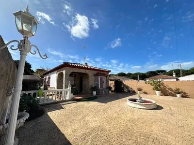 a house with a street light and a fountain at Chalet Aguacate in Chiclana de la Frontera