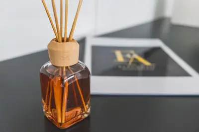 a bottle of oil with sticks in it on a table at Apartamento céntrico con piscina, temporada in El Puerto de Santa María