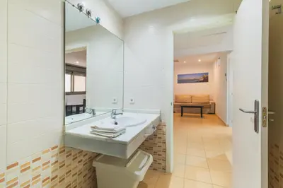 a bathroom with a sink and a toilet at Apartamento céntrico con piscina, temporada in El Puerto de Santa María
