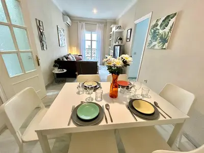 a white dining room table with white chairs and a table and chairsktop at GATU Guateque , 