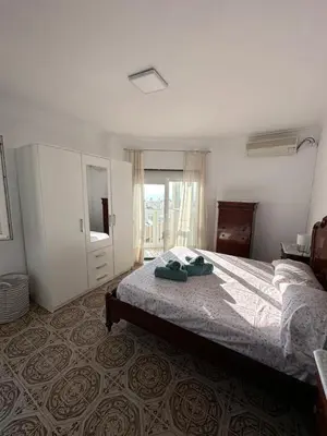 a bedroom with a bed and a dresser and a mirror at Apartamento Vista-Beach in Cádiz
