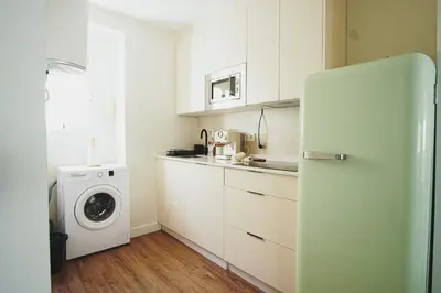 a kitchen with a refrigerator and a washing machine at Ocean View Ha Apartment in Cádiz