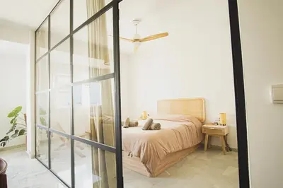 a bedroom with a bed with a ceiling fan at Ocean View Ha Apartment in Cádiz