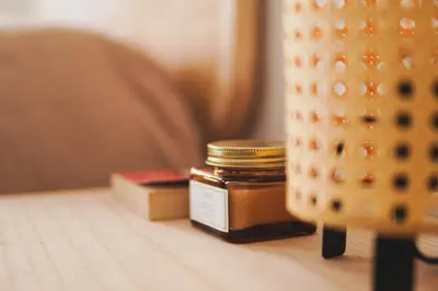 a jar of honey sitting on a table with books at Ocean View Ha Apartment in Cádiz