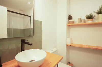 a bathroom with a white sink and a toilet at Ocean View Ha Apartment in Cádiz