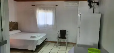 a small room with a table and a refrigerator at Estudios con piscina compartida en Complejo Rural el Mayorazgo in Cádiz