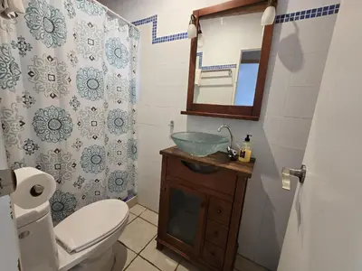 a bathroom with a sink and a toilet and a mirror at Estudios con piscina compartida en Complejo Rural el Mayorazgo in Cádiz