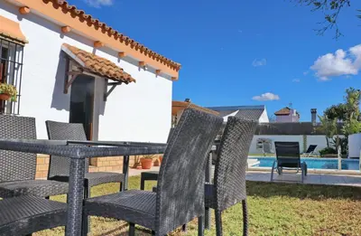 a table and chairs in the backyard of a house at Casa de los Abuelos in Hozanejos