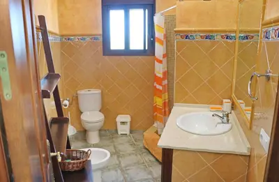 a bathroom with a sink and a toilet at Casa de los Abuelos in Hozanejos