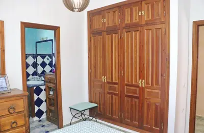 a room with a closet and a door and a stool at Casa de los Abuelos in Hozanejos