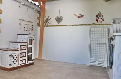 a living room with a white garage door with hearts on the wall at Casa de los Abuelos in Hozanejos
