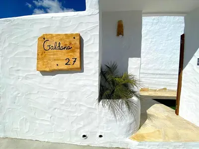 a sign on the side of a white building at GALDANA in Chiclana de la Frontera