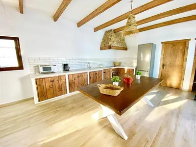 a kitchen with a wooden table in a room at GALDANA in Chiclana de la Frontera