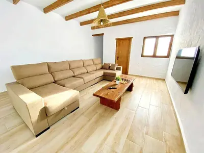 a living room with a couch and a table at GALDANA in Chiclana de la Frontera