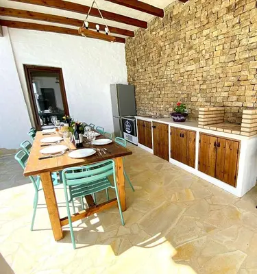 a kitchen with a table with chairs and a counter at GALDANA in Chiclana de la Frontera