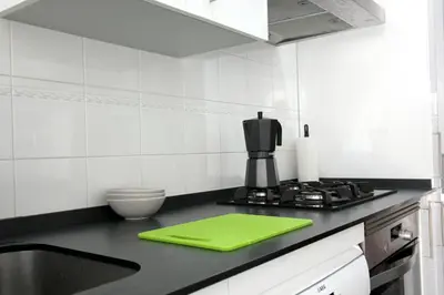 a kitchen with a green cutting board on a counter at ConiL Casa H&L in Conil de la Frontera