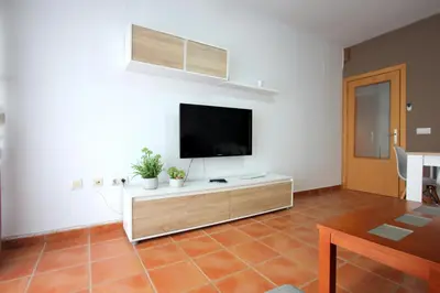 a living room with a flat screen tv on a wall at ConiL Casa H&L in Conil de la Frontera