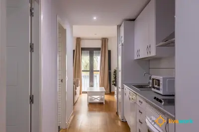a kitchen with white cabinets and a counter top at Estrella del Mar- FREE PARKING by LiveWork in Cádiz