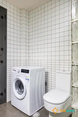 a bathroom with a washing machine and a toilet at Estrella del Mar- FREE PARKING by LiveWork in Cádiz