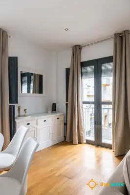 a living room with white furniture and a large window at Estrella del Mar- FREE PARKING by LiveWork in Cádiz