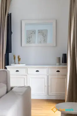 a white dresser in a living room with a mirror at Estrella del Mar- FREE PARKING by LiveWork in Cádiz