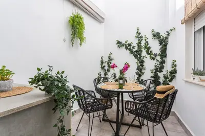 a glass table and chairs on a patio at San Miguel Tranquilo Moderno in Jerez de la Frontera