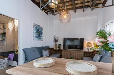 a patio with a table and chairs and plants at San Miguel Tranquilo Moderno in Jerez de la Frontera