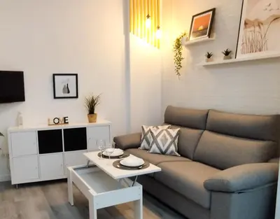 a living room with a couch and a table at Apartamento Poniente Sanlúcar - Centro in Sanlúcar de Barrameda