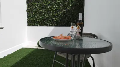 a table with a bowl of food and a bottle of wine at Apartamento Poniente Sanlúcar - Centro in Sanlúcar de Barrameda