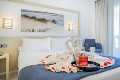 a hotel room with a bed with a tray with a table at Hotel Spa Cádiz Plaza in Cádiz