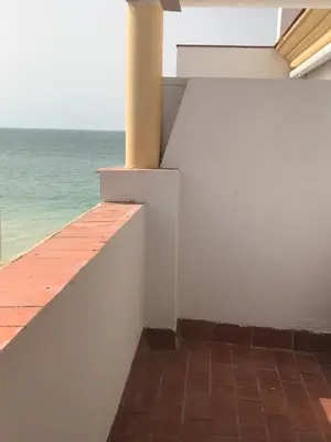 a balcony with a view of the ocean at Apartamento DUPLEX CRUZ DEL MAR in Chipiona