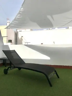 a black bench sitting on top of a boat at Apartamento DUPLEX CRUZ DEL MAR in Chipiona