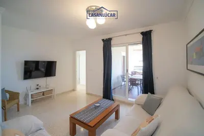 a living room with a couch and a table at Apartamento Cigüeña in Sanlúcar de Barrameda