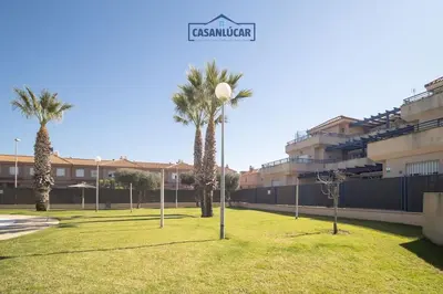 a park with palm trees and a street light at Apartamento Cigüeña in Sanlúcar de Barrameda