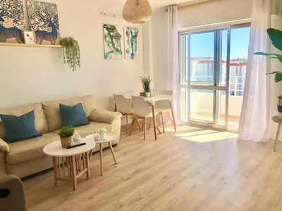 a living room with a couch and a table at Frente al mar, preciosas vistas, piscinas , valdelagrana in El Puerto de Santa María