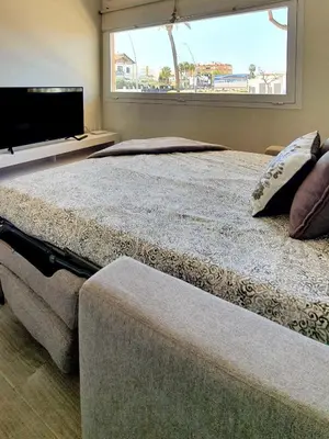 a bedroom with two beds and a large window at Playa Doñana 2 in Sanlúcar de Barrameda