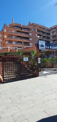 a gate with signs in front of a building at Playa Doñana 2 in Sanlúcar de Barrameda