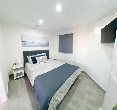 a bedroom with a bed in a white room at Playa Doñana 2 in Sanlúcar de Barrameda