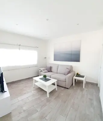 a living room with a couch and a table at Playa Doñana 2 in Sanlúcar de Barrameda