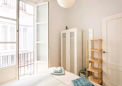 a bedroom with a mirror next to a window at Apartamento luminoso y céntrico in Cádiz
